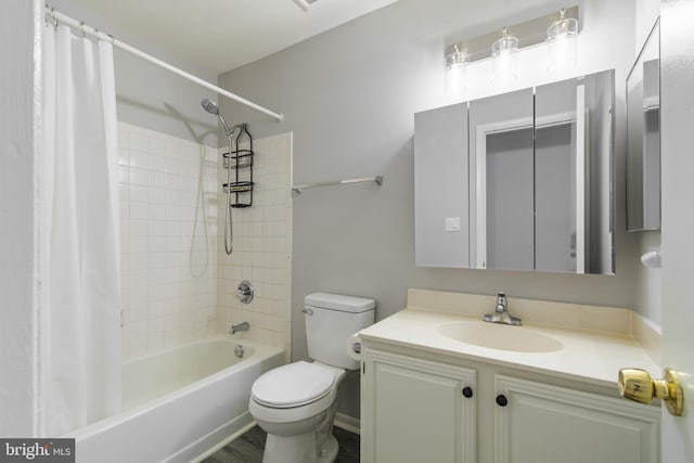 bathroom with shower / tub combo, toilet, and vanity