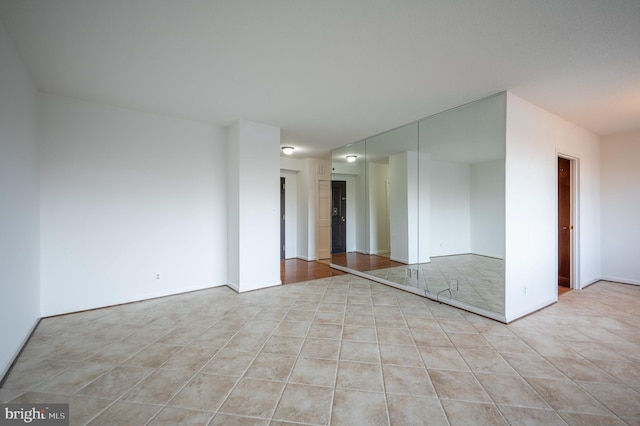 unfurnished room featuring light tile patterned floors