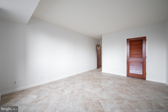 unfurnished room featuring light tile patterned floors