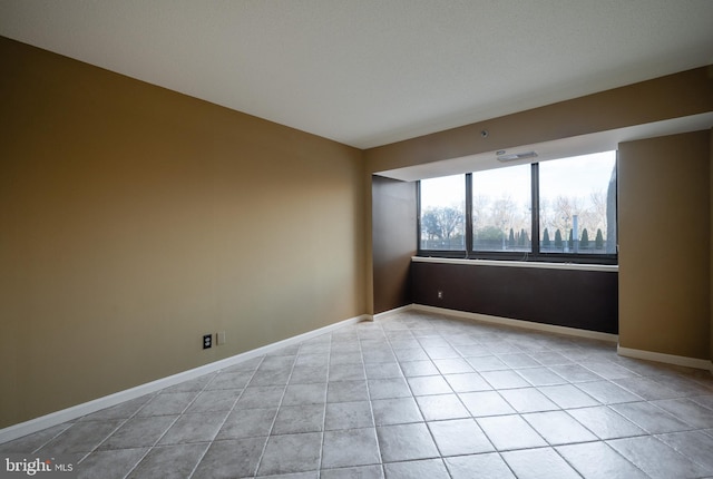 empty room with light tile patterned flooring