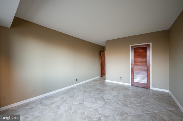 spare room featuring light tile patterned flooring