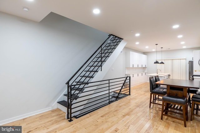 dining room featuring sink and light hardwood / wood-style floors