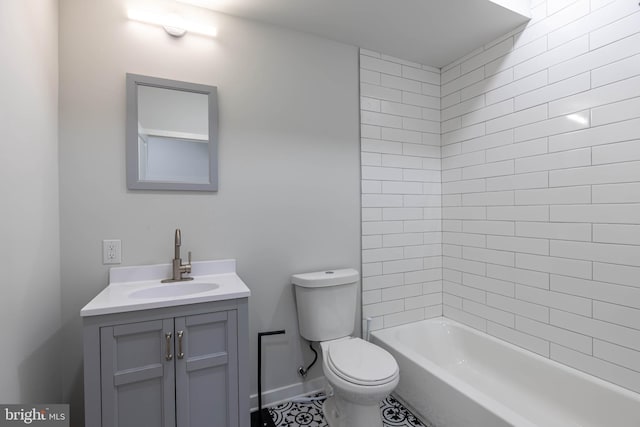 full bathroom with tiled shower / bath, vanity, and toilet