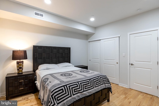 bedroom with a closet and light hardwood / wood-style flooring