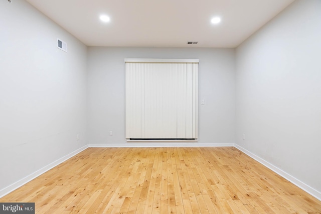 unfurnished room featuring hardwood / wood-style flooring