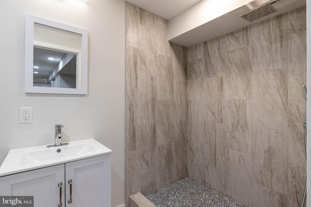 bathroom featuring vanity and a tile shower