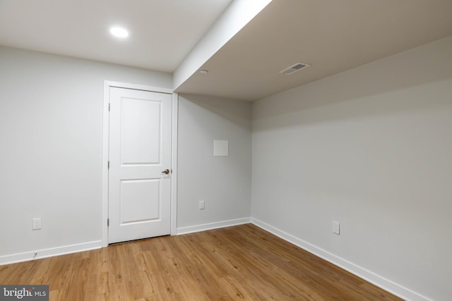 basement with light hardwood / wood-style flooring