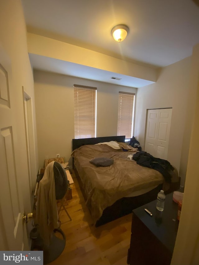 bedroom with a closet and light hardwood / wood-style flooring