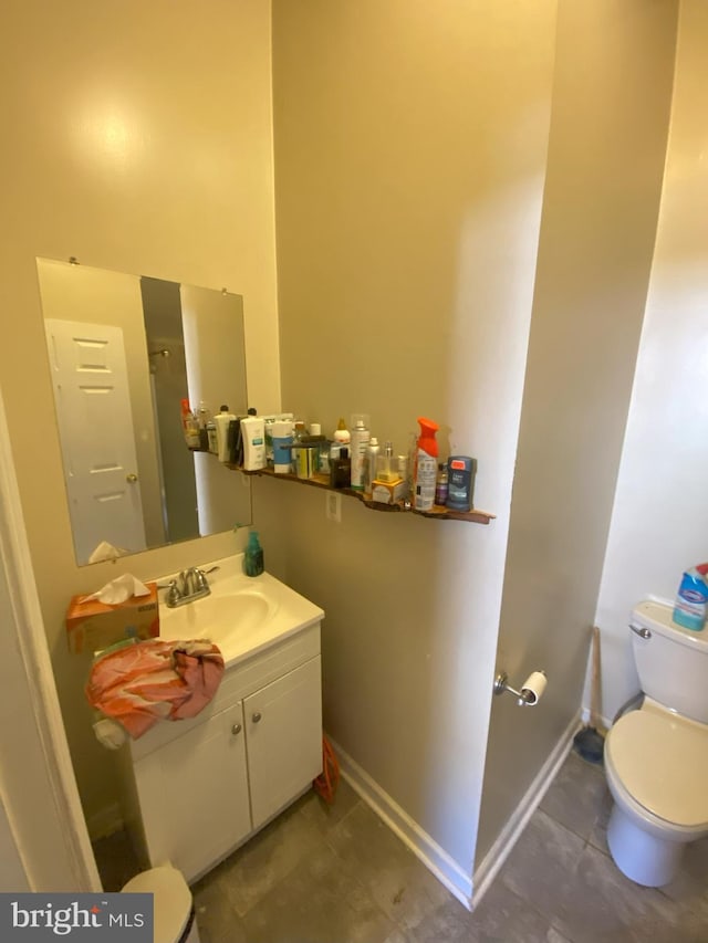 bathroom featuring tile patterned floors, vanity, and toilet