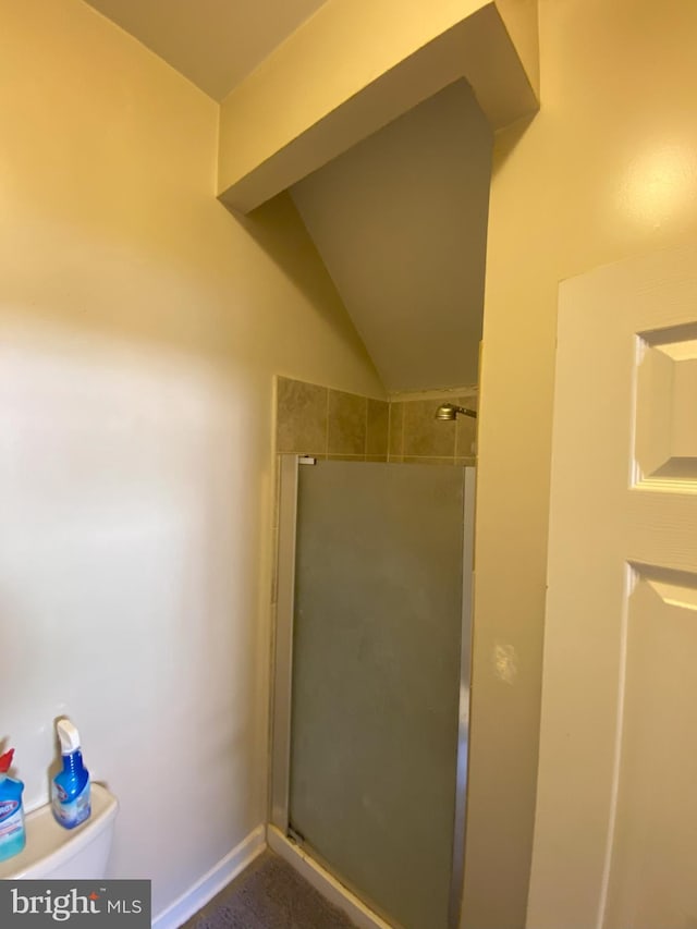 bathroom featuring an enclosed shower and toilet