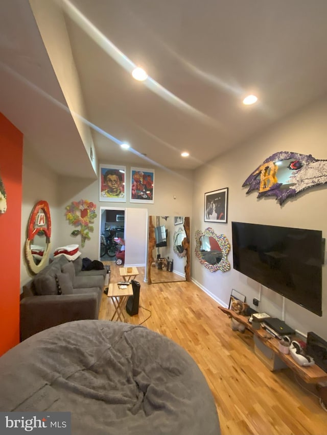 living room with lofted ceiling and hardwood / wood-style floors