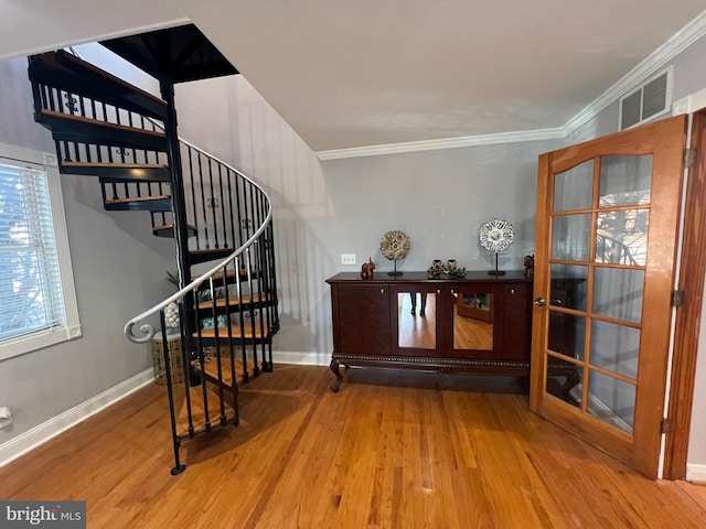 interior space with hardwood / wood-style flooring and ornamental molding