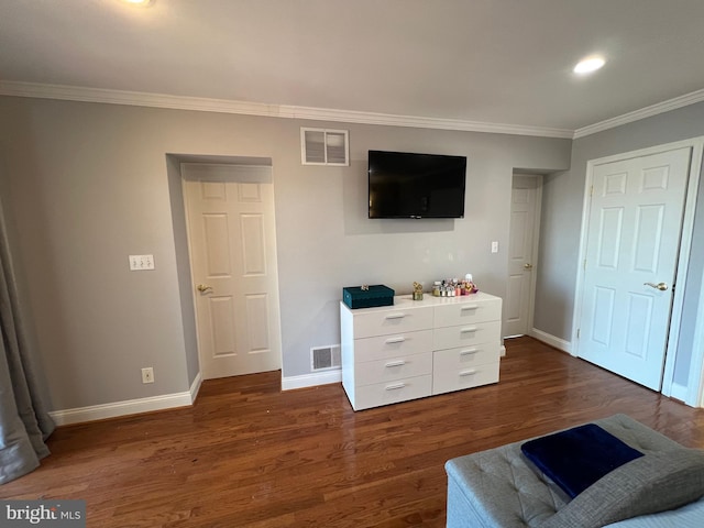 living area with crown molding and dark hardwood / wood-style flooring