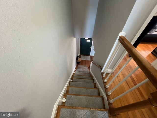 stairway featuring wood-type flooring