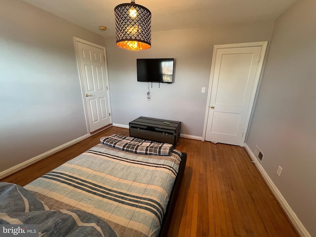 bedroom with hardwood / wood-style flooring