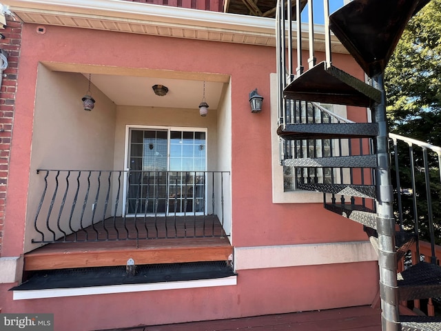 view of exterior entry featuring a balcony