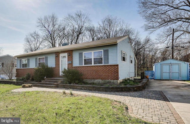 view of front of home with a shed and a front lawn