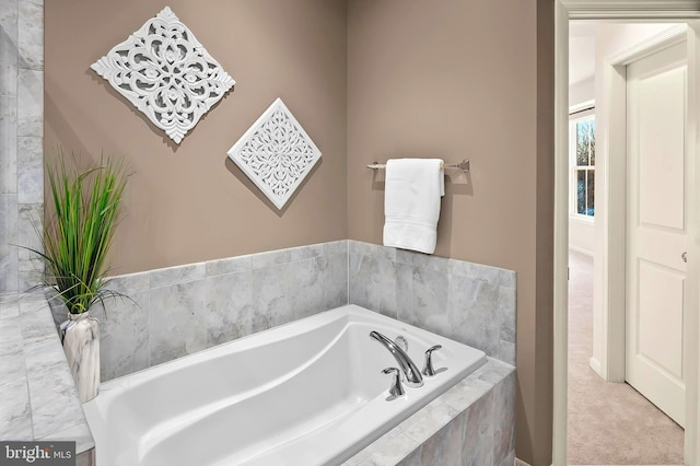 bathroom with a relaxing tiled tub