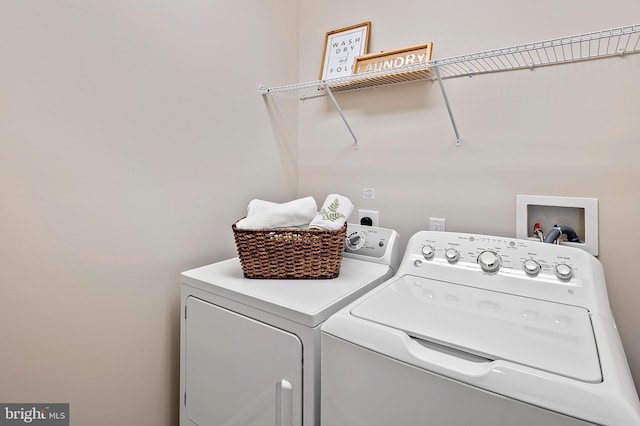 washroom with washing machine and clothes dryer