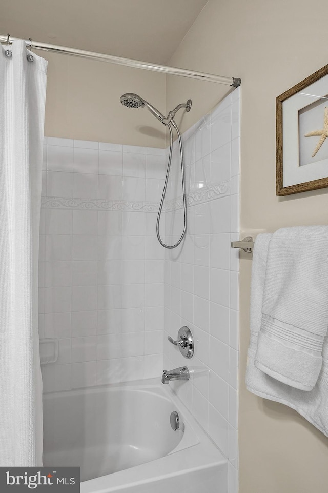 bathroom with shower / tub combo with curtain