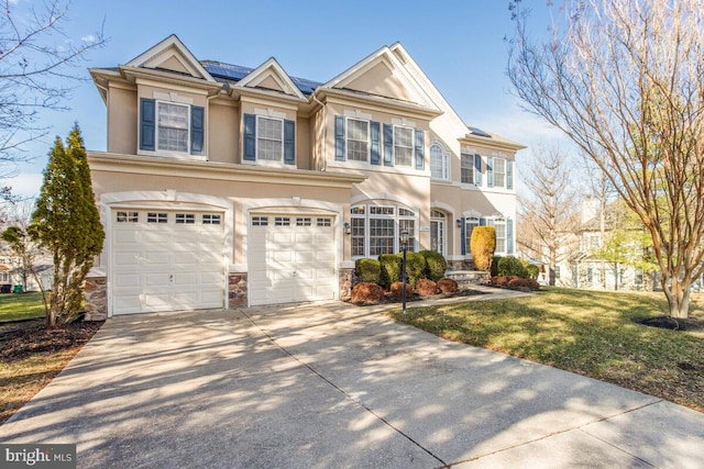 view of front of home with a garage and a front yard