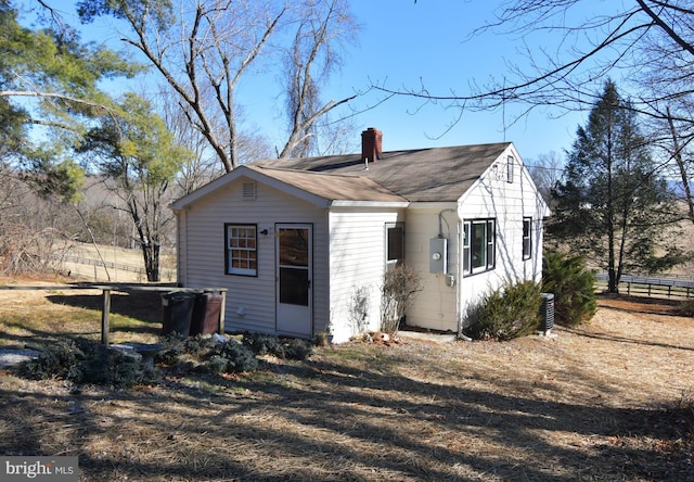 exterior space with a chimney and fence