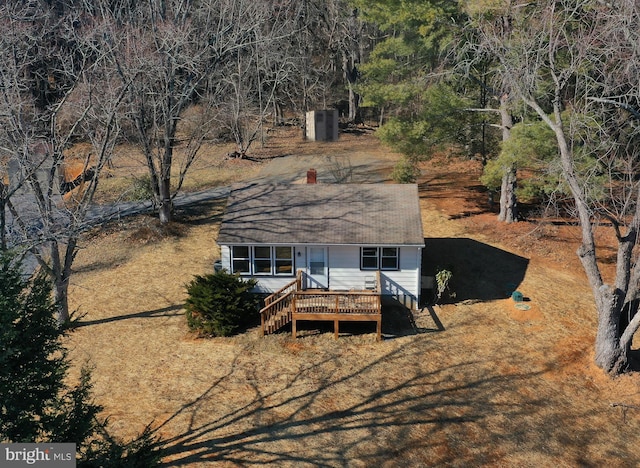 exterior space with a wooden deck and a storage shed