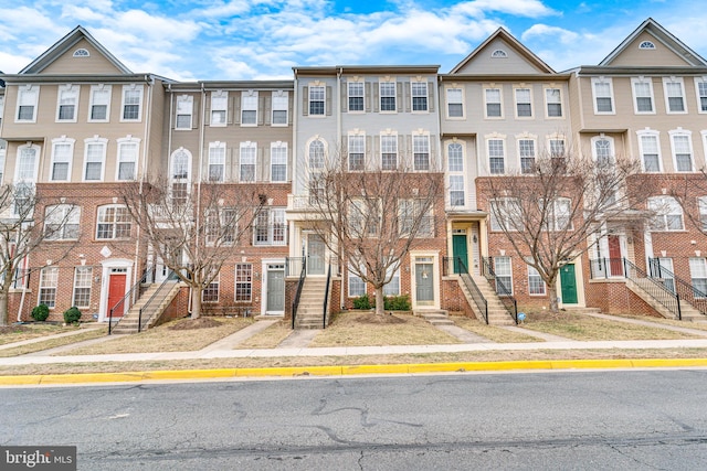 townhome / multi-family property with brick siding