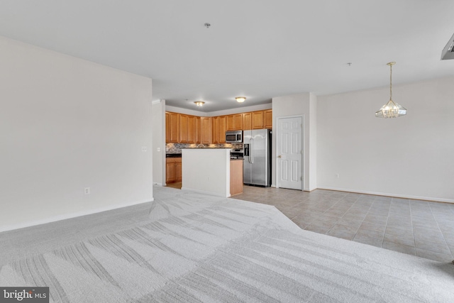 unfurnished living room featuring light tile patterned floors and baseboards