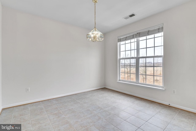 empty room with a notable chandelier, baseboards, visible vents, and light tile patterned floors