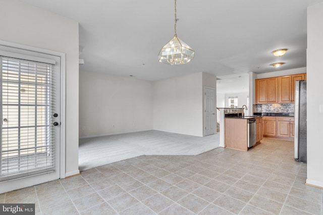 kitchen with dark countertops, open floor plan, a wealth of natural light, and stainless steel appliances