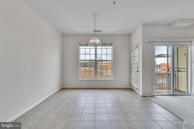 unfurnished dining area with visible vents, light carpet, a notable chandelier, light tile patterned floors, and baseboards