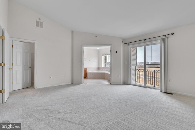 unfurnished living room featuring light carpet, visible vents, and lofted ceiling