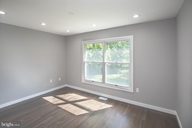 unfurnished room with baseboards, dark wood-style floors, and recessed lighting