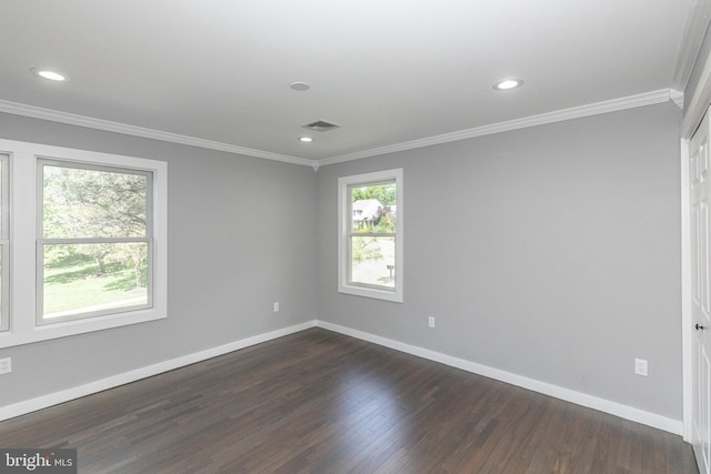 empty room featuring crown molding, baseboards, recessed lighting, and dark wood-style floors