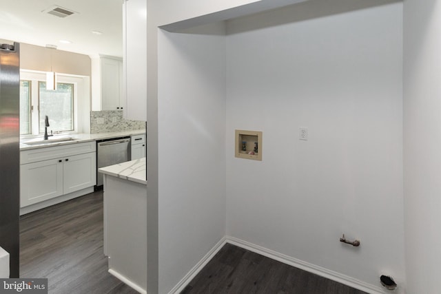 laundry room featuring washer hookup, dark wood-style floors, and baseboards