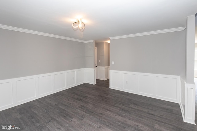 empty room featuring ornamental molding, dark wood-style floors, a wainscoted wall, and a decorative wall