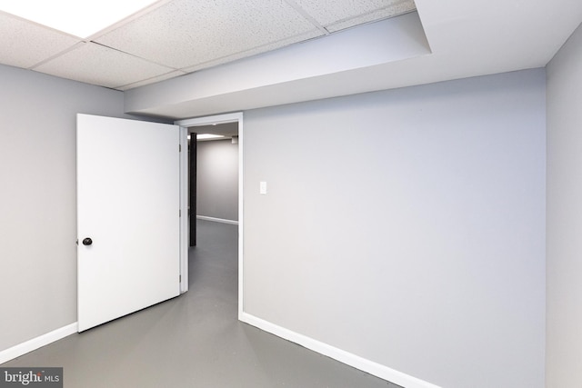 finished below grade area featuring baseboards and a drop ceiling