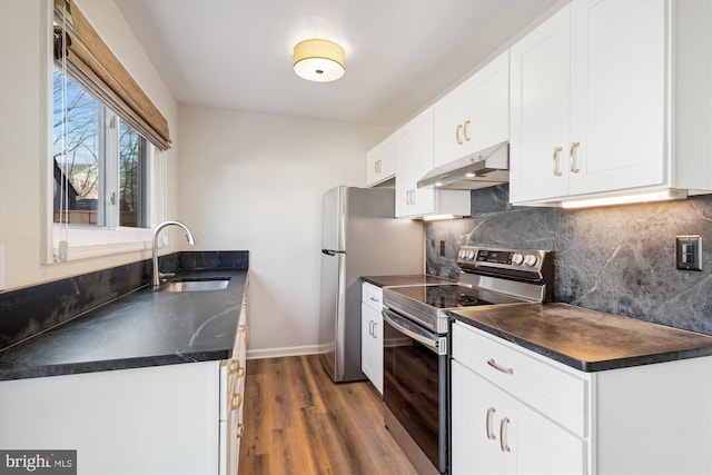 kitchen featuring sink, white cabinetry, stainless steel appliances, dark hardwood / wood-style flooring, and decorative backsplash