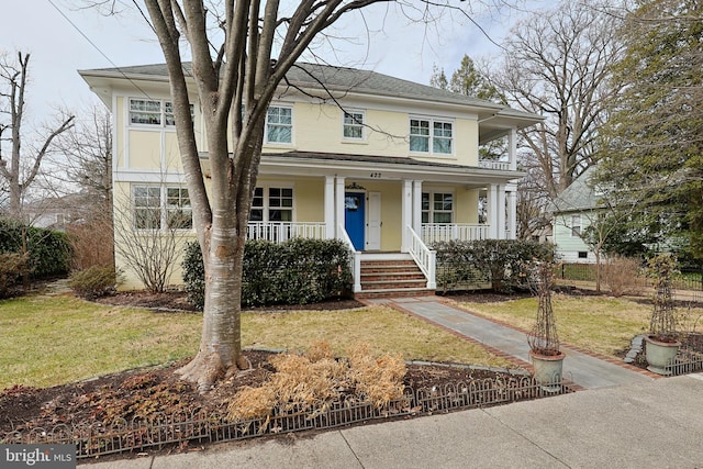 view of front of property with covered porch and a front lawn