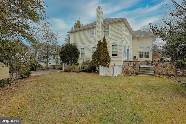 back of house with a lawn