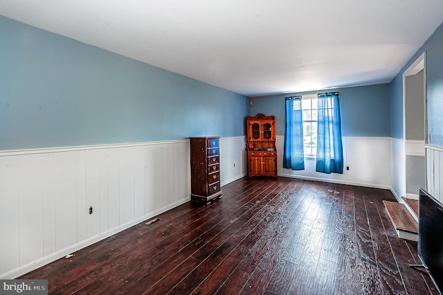 unfurnished living room featuring dark hardwood / wood-style flooring