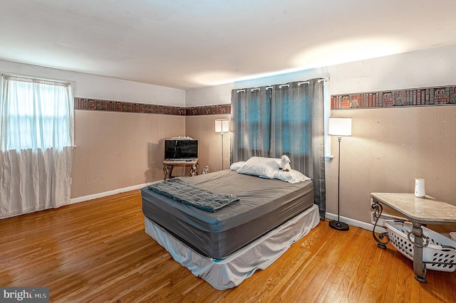 bedroom with hardwood / wood-style floors