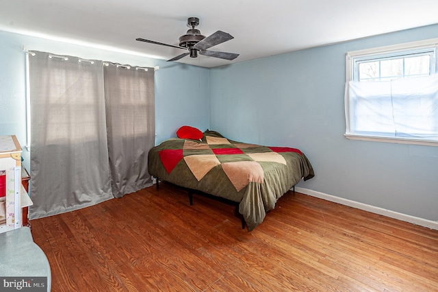 bedroom featuring hardwood / wood-style flooring and ceiling fan