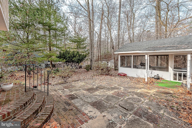 view of patio with a sunroom