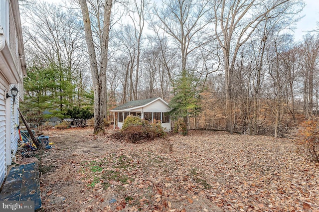 view of yard featuring a sunroom