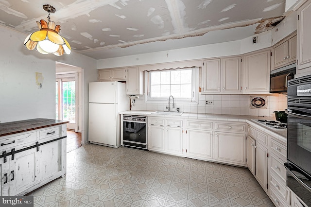 kitchen with sink, decorative backsplash, and black appliances