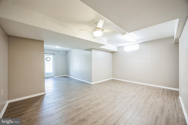 basement with ceiling fan and light wood-type flooring