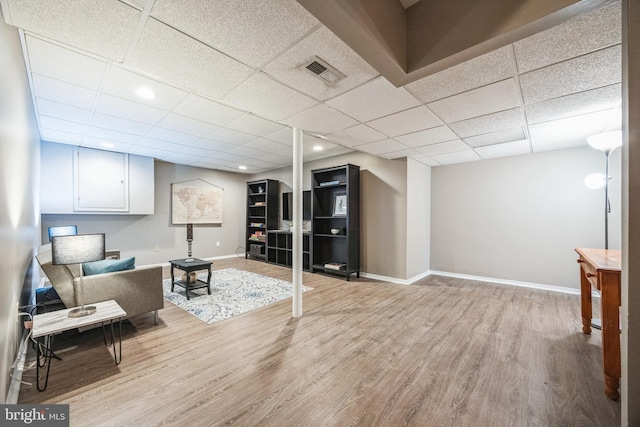 sitting room featuring light hardwood / wood-style flooring and a drop ceiling