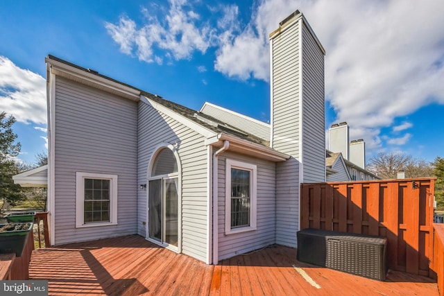 back of house featuring a wooden deck